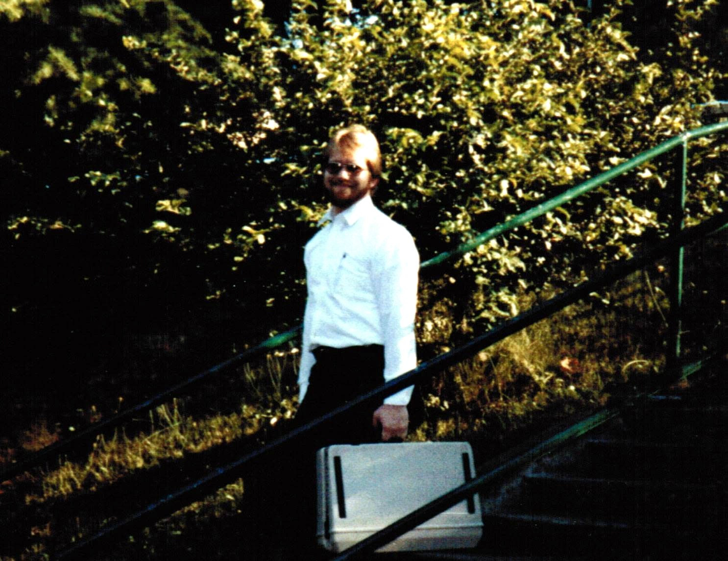 Dan Holland in Seattle in 1982, carrying an Osborne 1 portable computer up a stairway on his way to a consulting site
